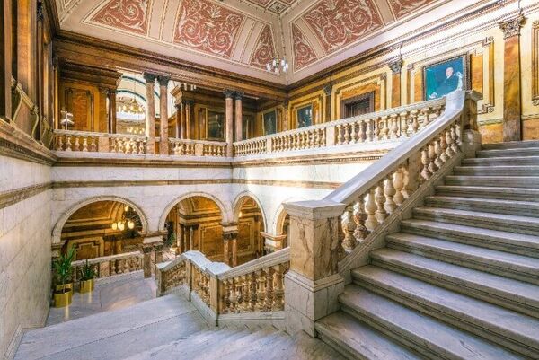 Taken from inside the City Chambers, there is a beautiful staircase with carved bannisters, portraits hanging and the ceiling is high and appears to be intricately painted.