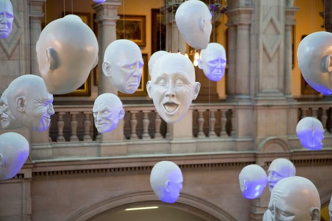 The Floating Heads installation at the Kelvingrove Art Gallery and Museum, with each head displaying different emotions.