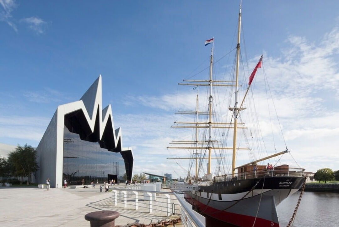 A side view of the Riverside Museum building and the Tall Ship on the River Clyde