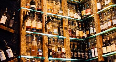 A selection of whiskies on shelves inside the Ben Nevis bar in Glasgow.