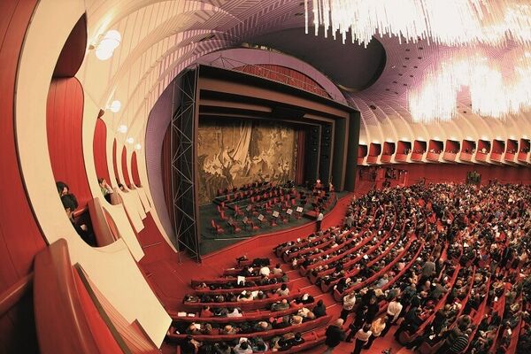 The interior of Regio Opera Theatre in Torino, with an audience enjoying a performance.