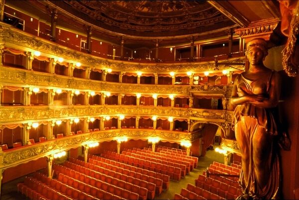 The interior of Carignano Theatre in Torino. The venue is empty and there is a statue on the right hand side.