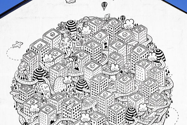 Millo via Tollegno, a mural on the side of a building in Torino. It shows a busy city in black and white paint.