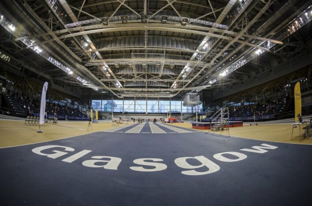 An indoor running track with 'Glasgow' written on it