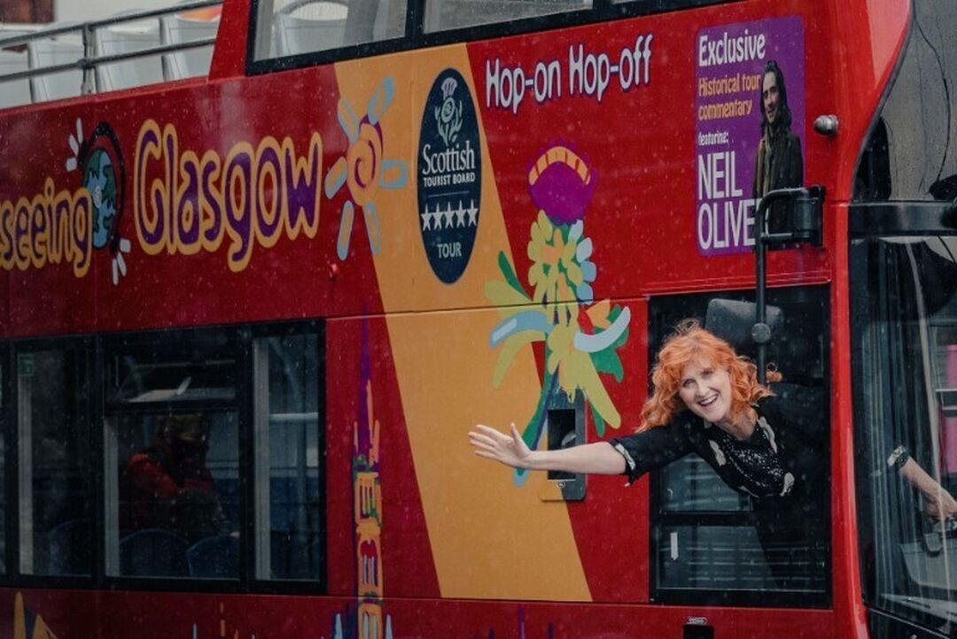 Eddi Reader hangs out the side window on the city sightseeing bus tour.