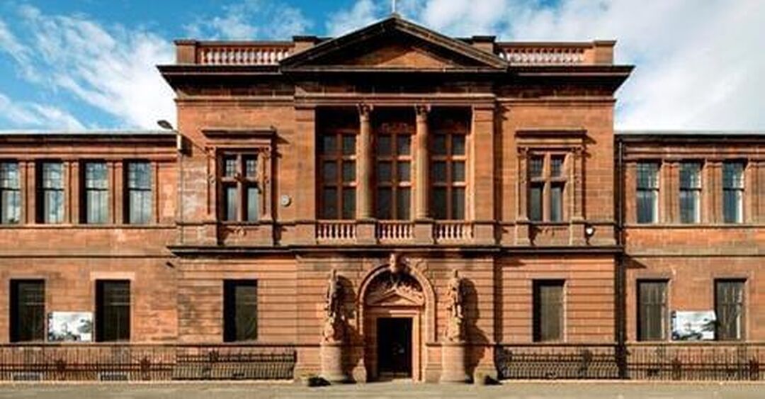 A red sandstone building with rectangle windows.