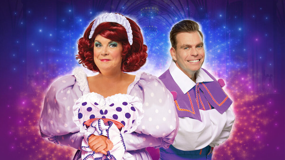 Two people dressed in traditional pantomime costume against a sparkly purple and blue background.