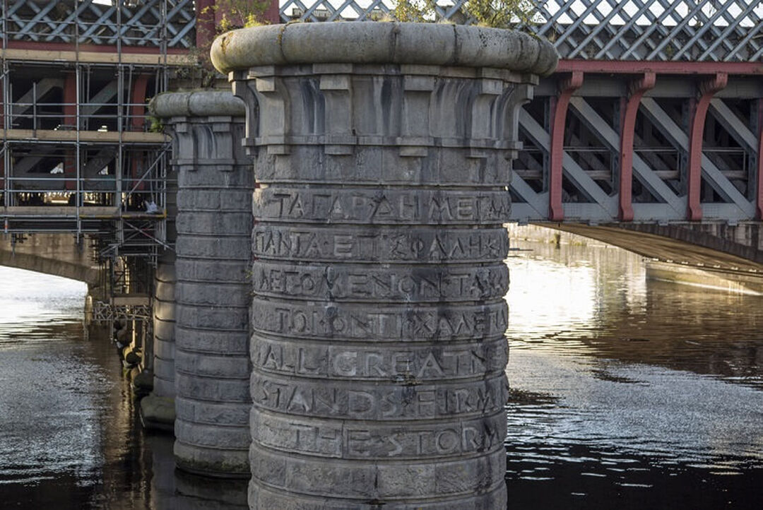 A bridge column on the River Clyde in Glasgow city centre with the phrase ‘all greatness stands firm in the storm' carved onto it.